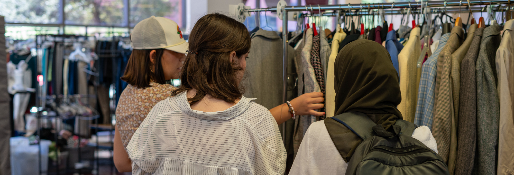 students browse clothing items at the OU Career Closet event. 