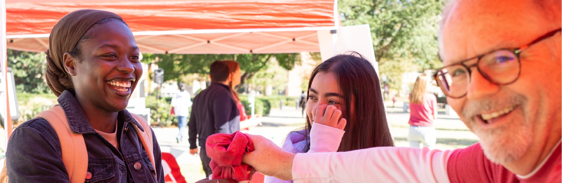 student receiving a free t-shirt from a career center employee during careerapalooza