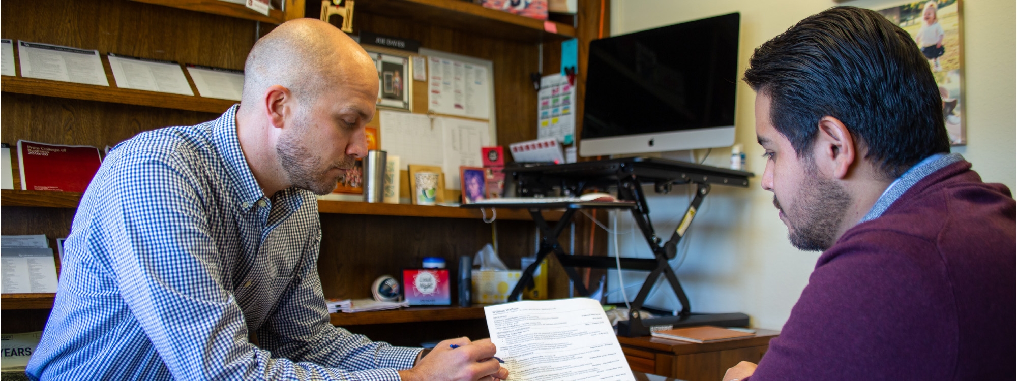 a career center employee and student looking over a resume