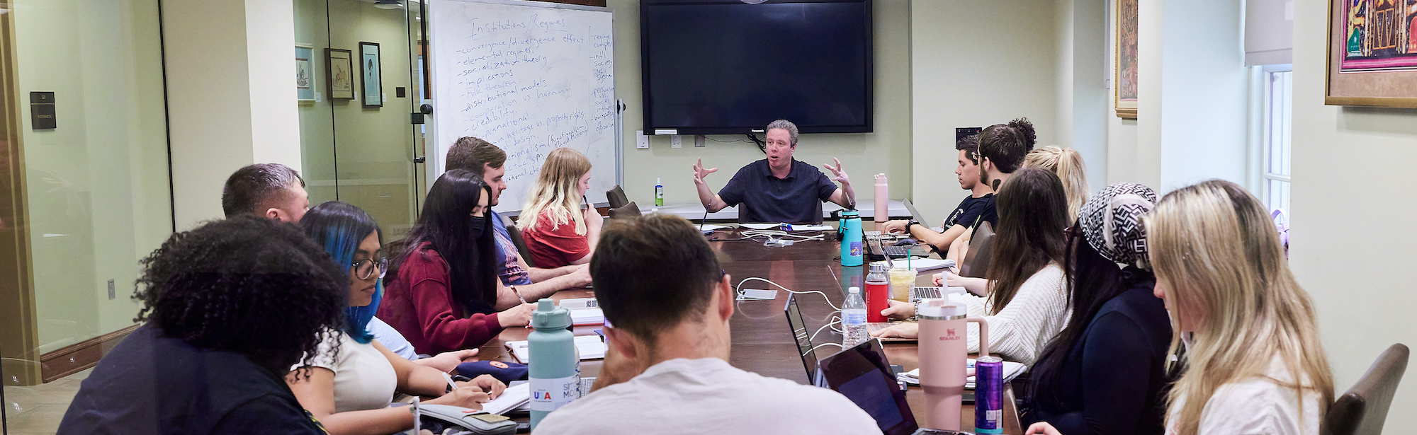 Graduate Students in class with Professor Mark Raymond.