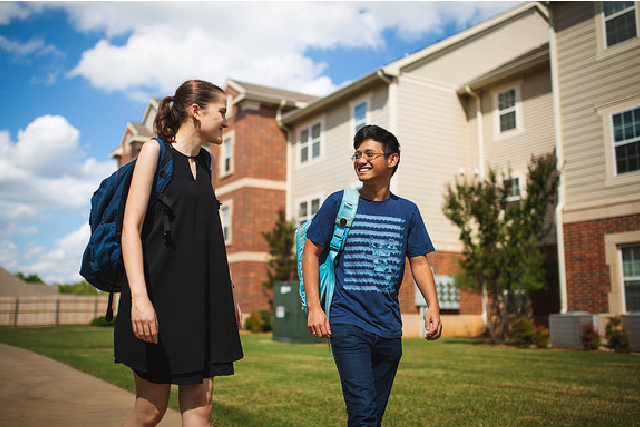 Two students walk outside of Traditions Square