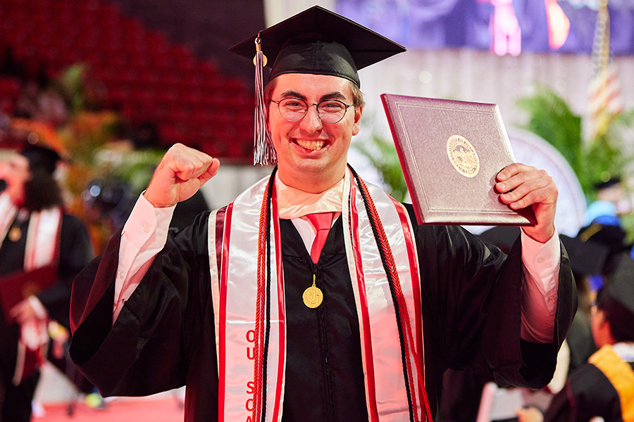 A student with their diploma.