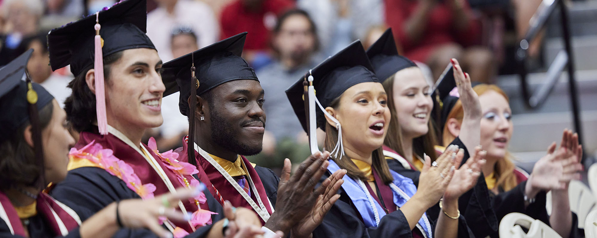 Graduates clapping during ceremony.