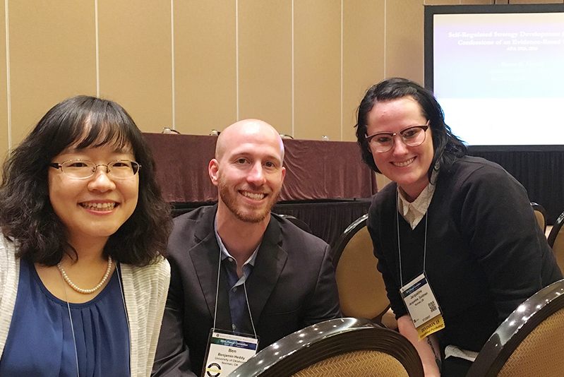 Ji Hong, Ben Heddy and student posing for a picture