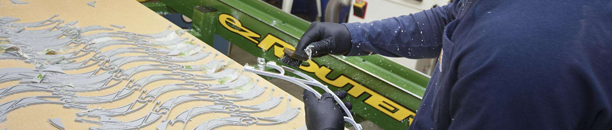 Kolton Topetchy, a tech lead with the Tom Love Innovation Hub, cleans and prepares CNC-cut frame components for more than 80 face shields produced using rapid-prototyping techniques. 