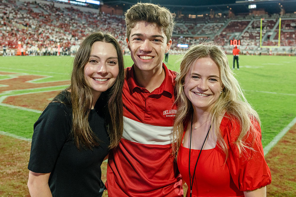 Katelyn Foster, Noah Bryan, Acacia McDonald, Sooner Sports Properties interns at OU football game