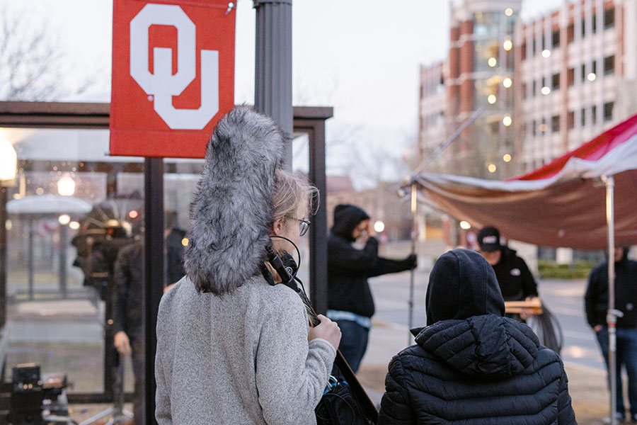 Students holding filming equipment during production on OU Norman campus.