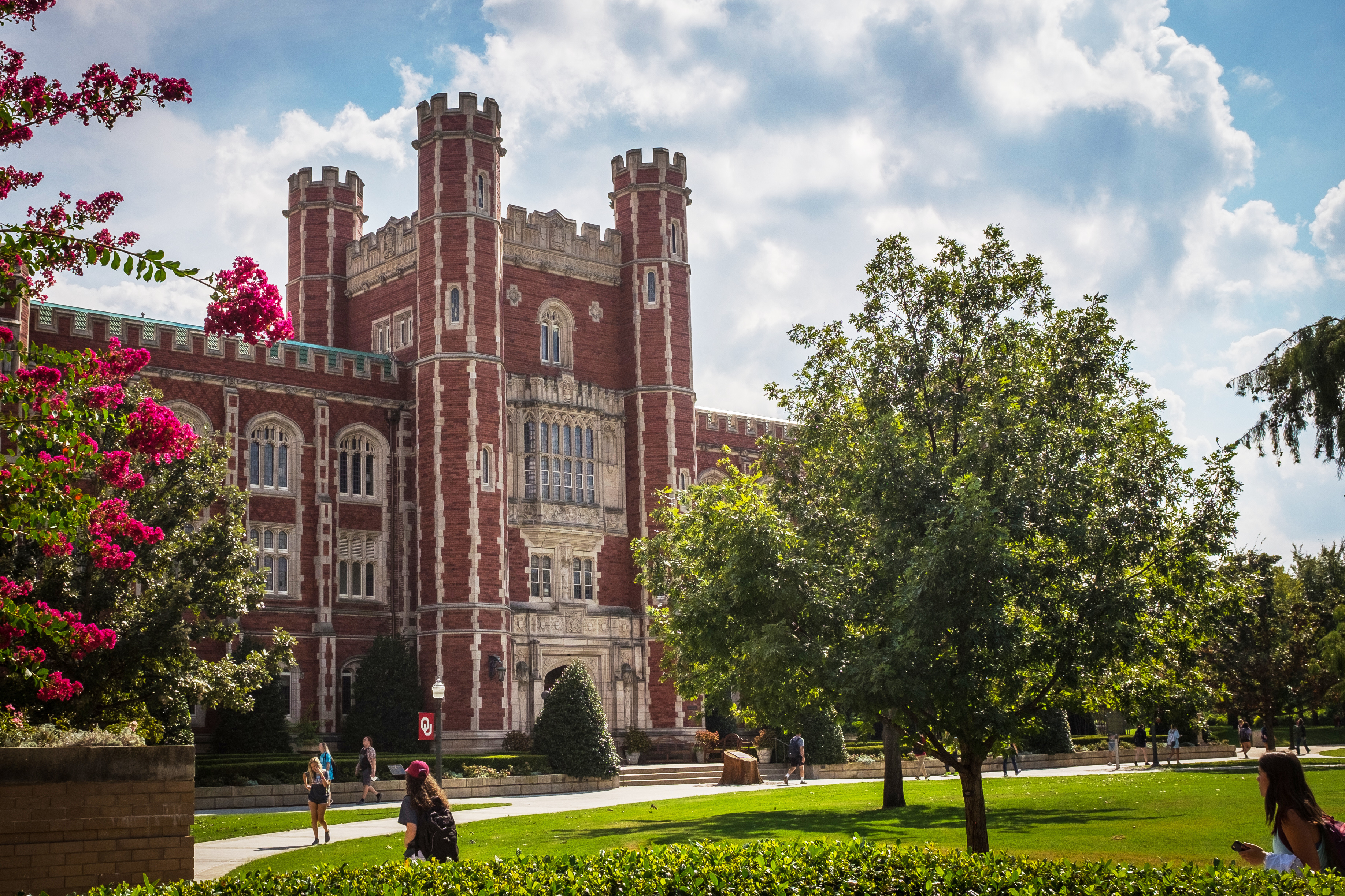 Evans Hall on a sunny day with clouds in the sky.