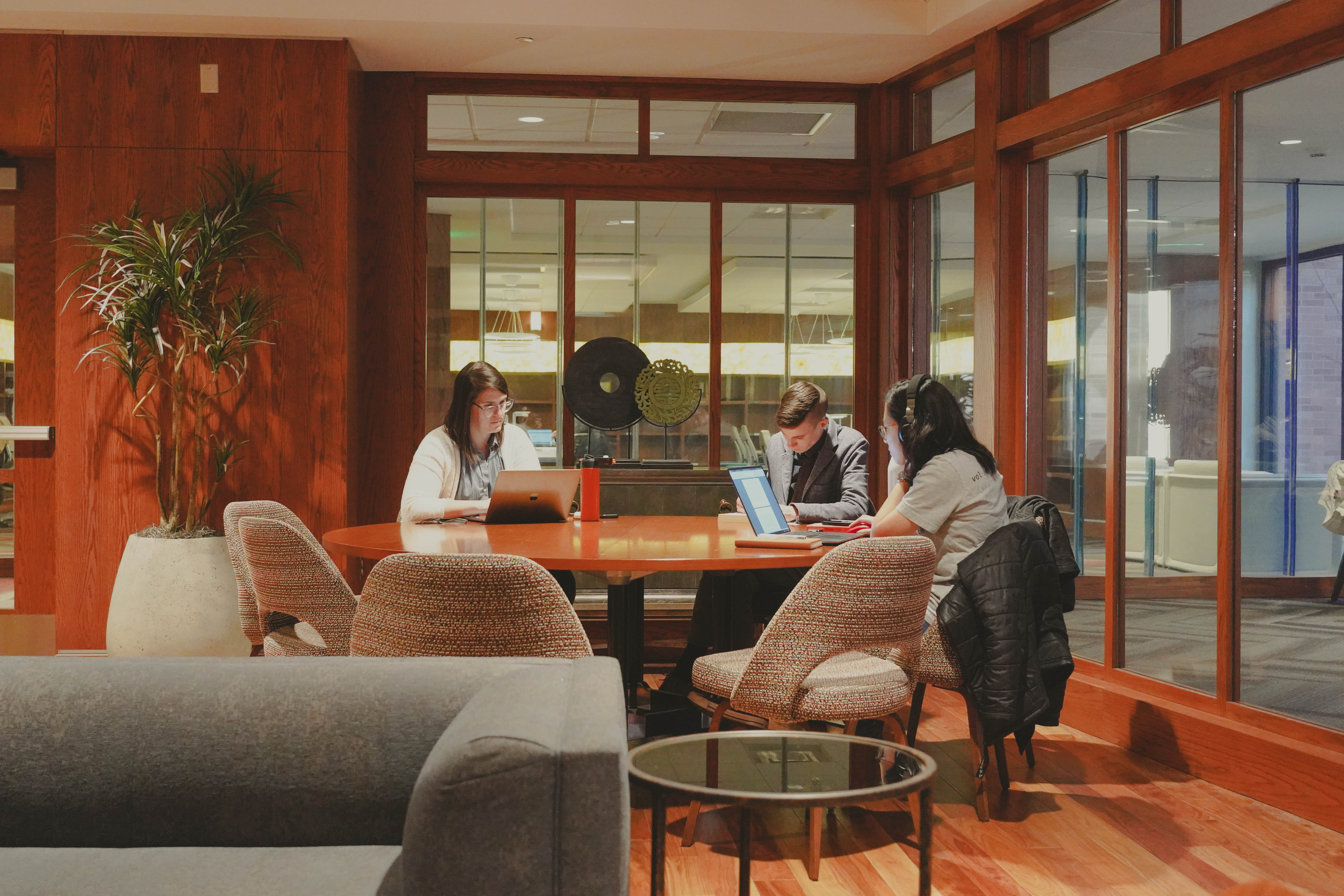 Students and faculty working at a table in the graduate lower level 2 library.