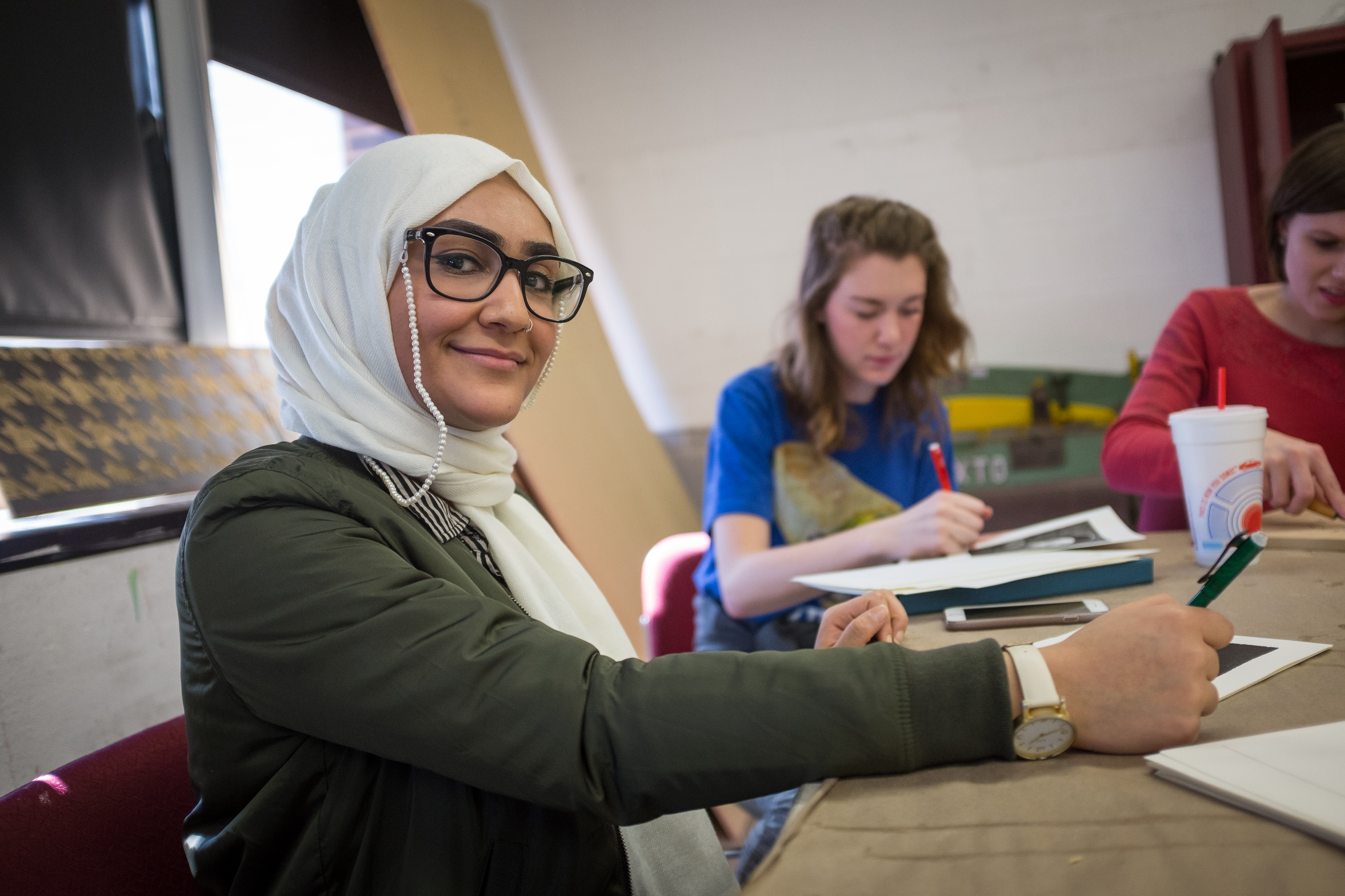 student sitting at table and doing work