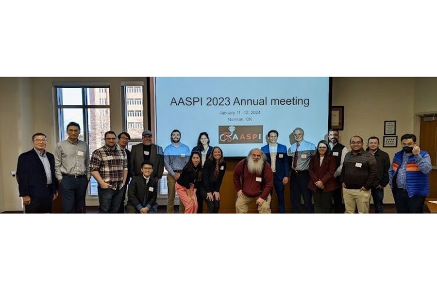 Researchers standing in front of a projection screen.