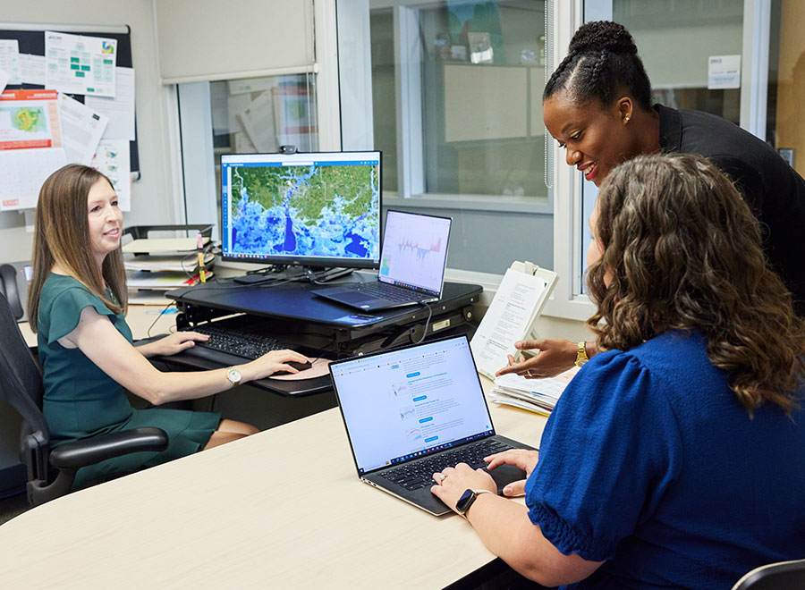 The OU SCIPP team examines flood data on their computers.