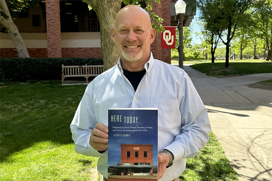 Jeffrey Schmidt holding his book.