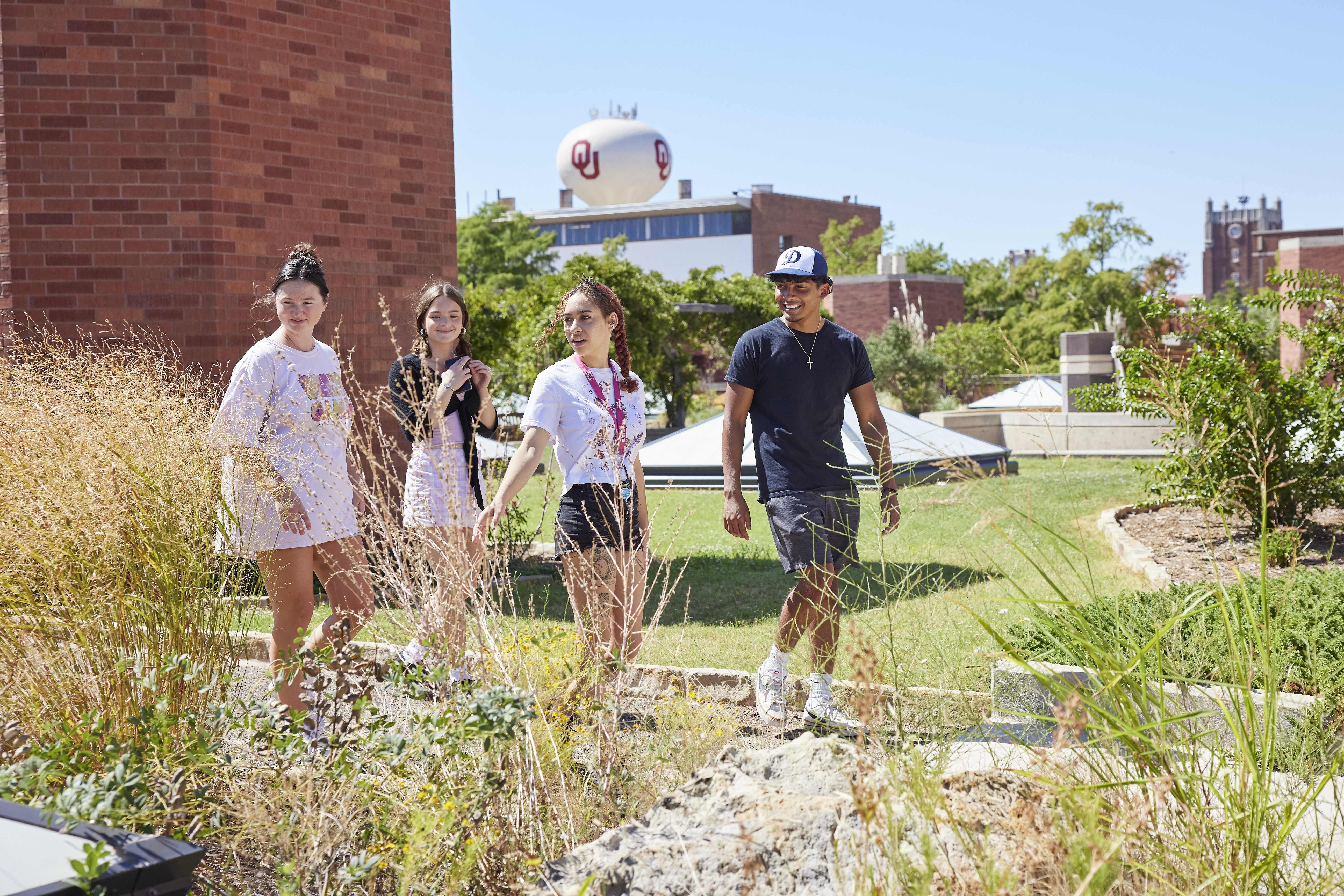 Students walking through a butterfly garden.