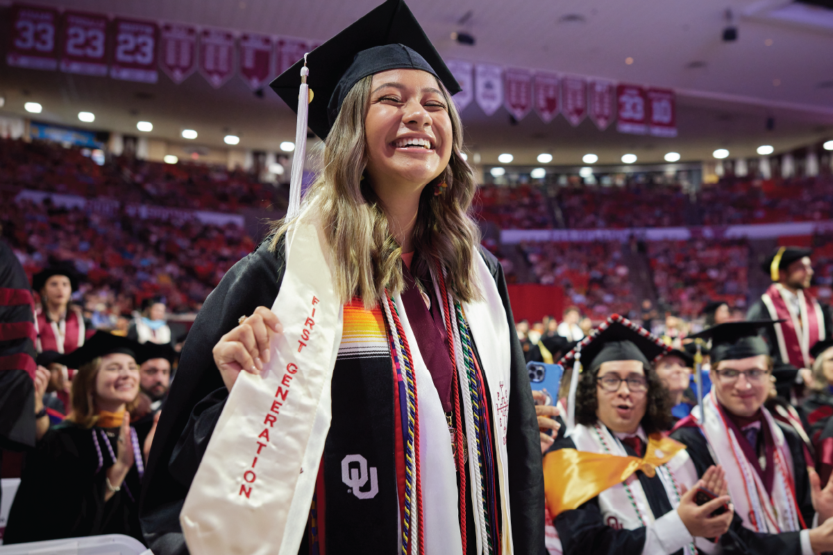 First Generation student stands during convocation ceremony to be recognized for this accomplishment