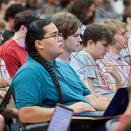 College student in class next to others.