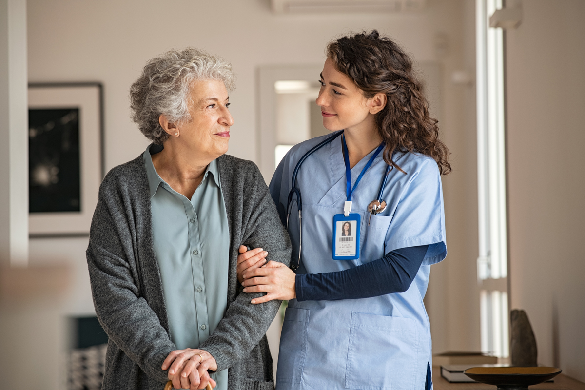 Elderly woman with caretaker