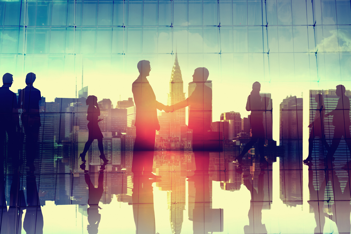 stock image of people shaking hands in business environment