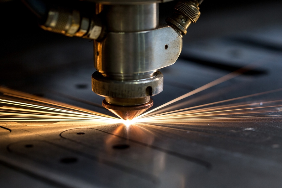 Cutting of metal. Sparks fly from laser