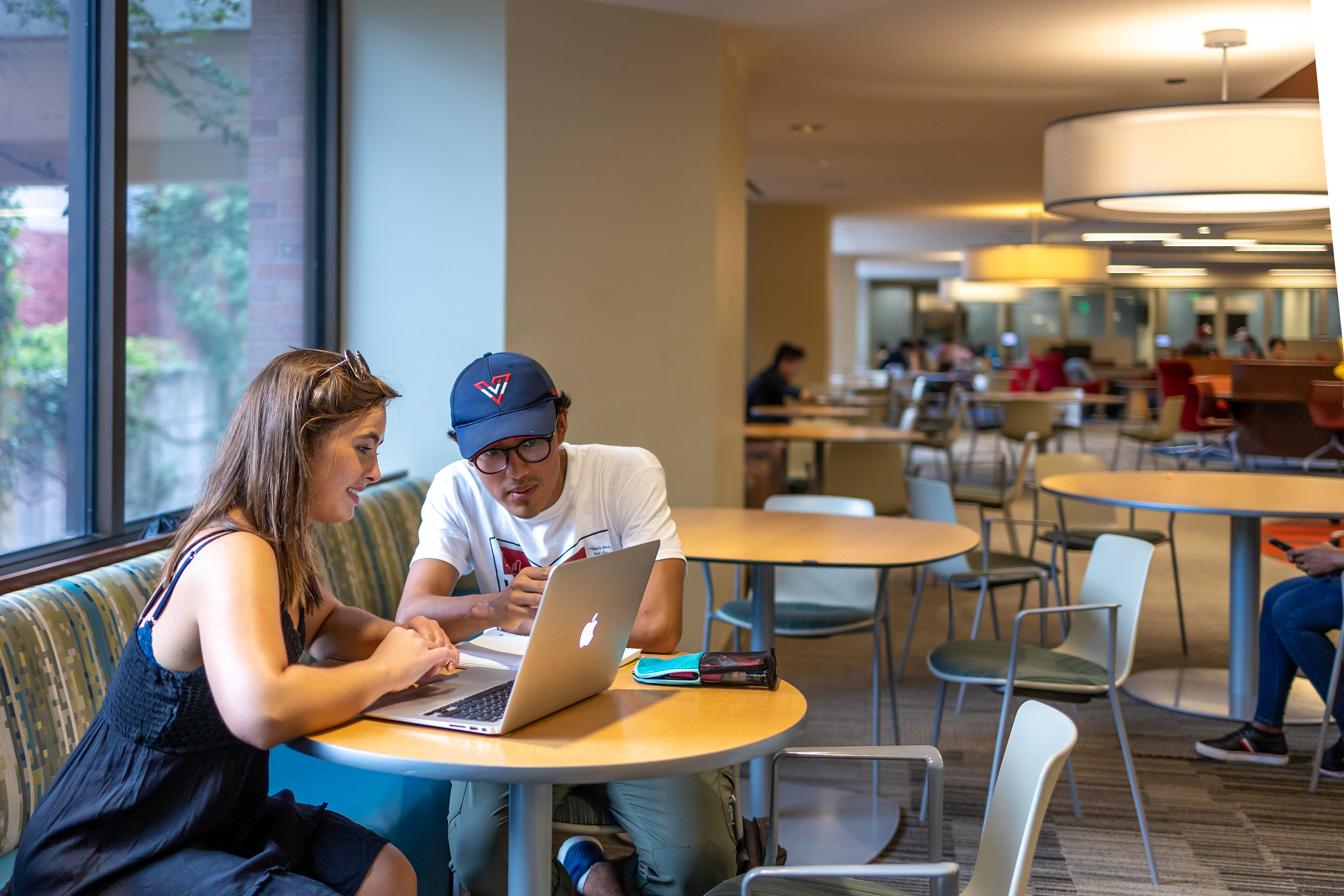 Two students working on computer in library