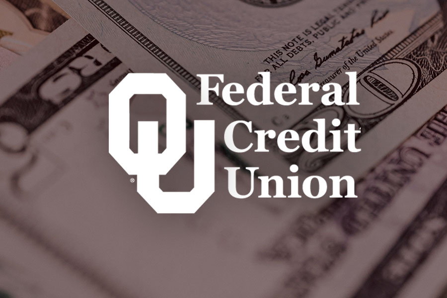 The OU Federcal Credit Union in white on top of loose bills of money.