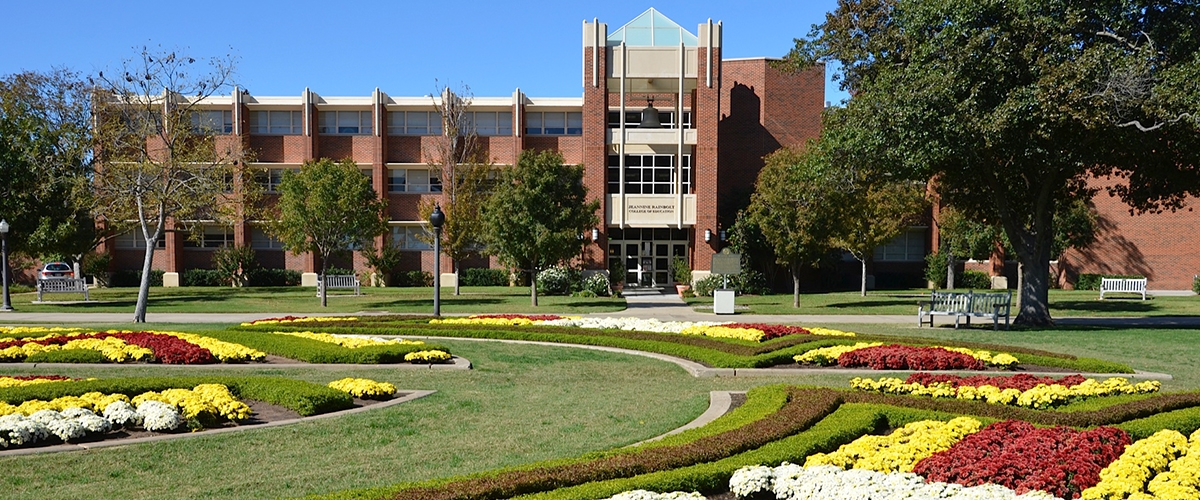 Distance shot of Collings Hall with flowers