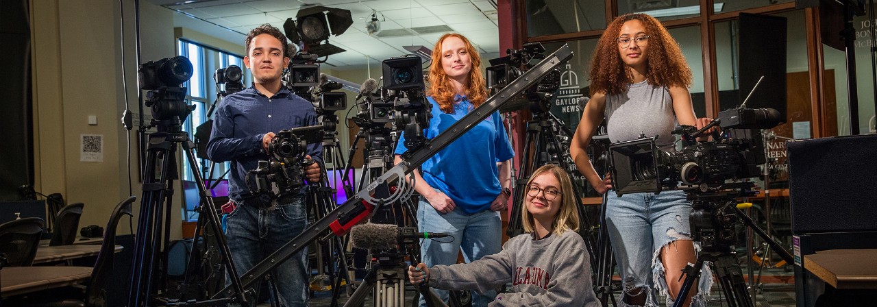 Gaylord College students looking at drone during live shoot