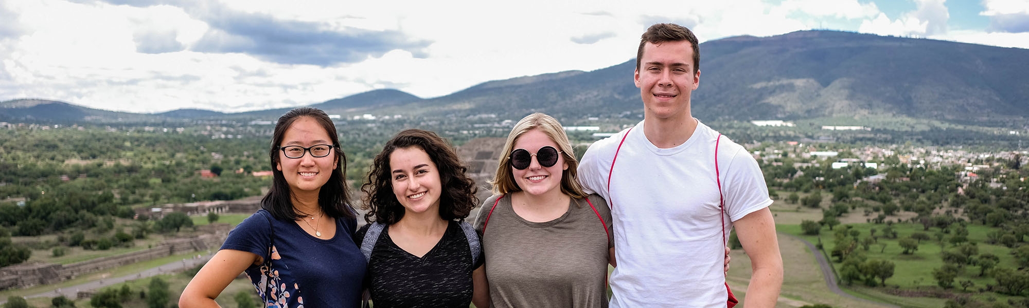 Students posing in front of mountains