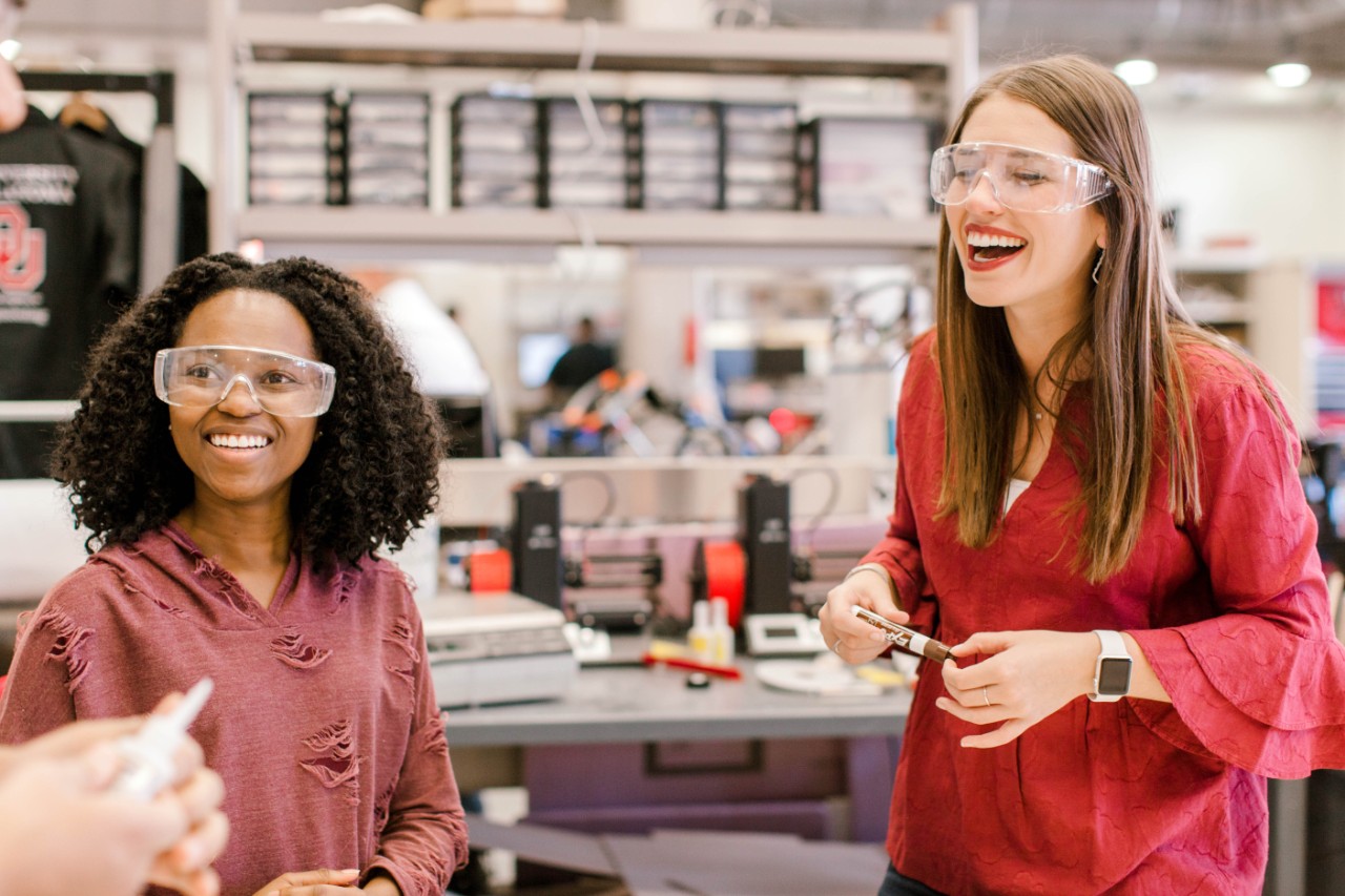 photo of two female students wearing safety glasses