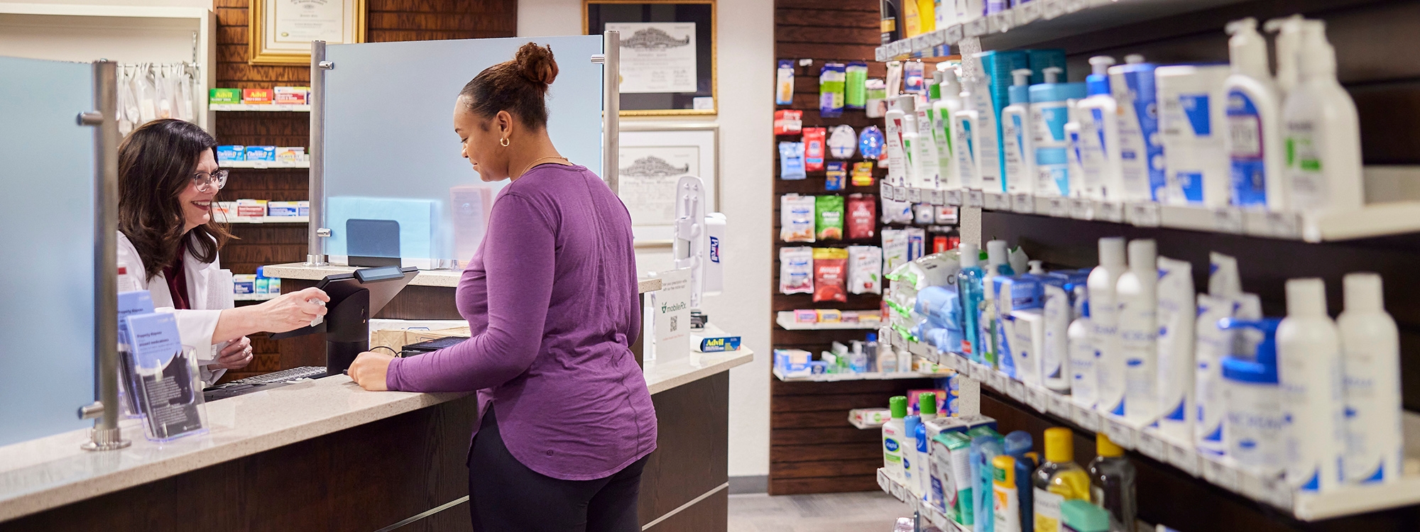 Pharmacist talking to patient about their prescription