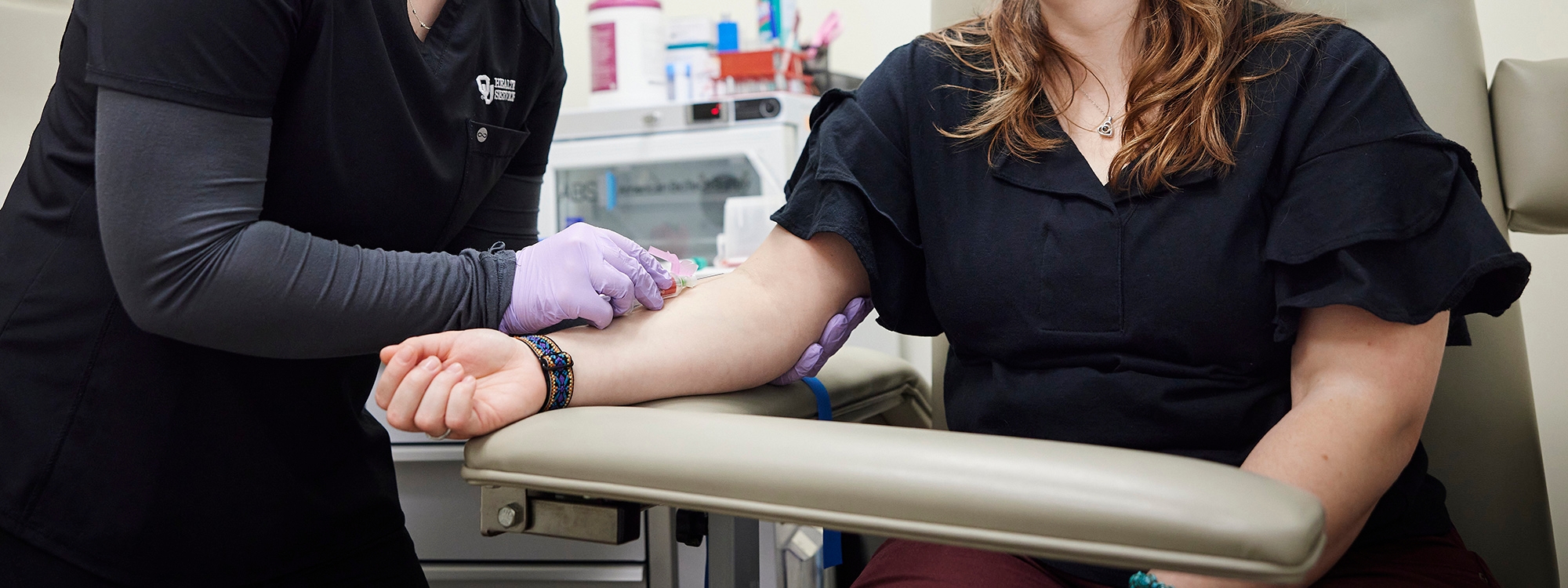 Medical professional taking blood from patient