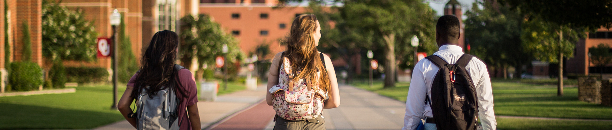 Three students walking on OU's campus.