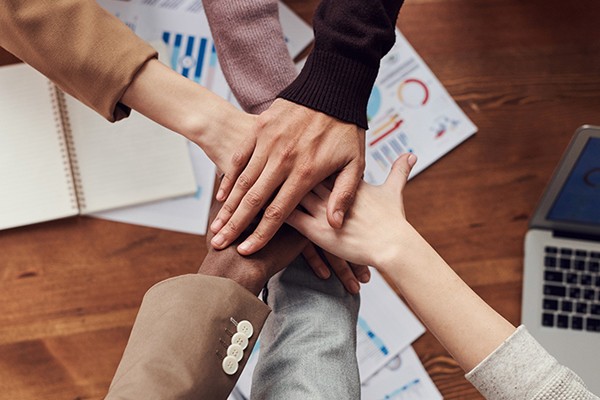 team members stacking their hands on top of each other