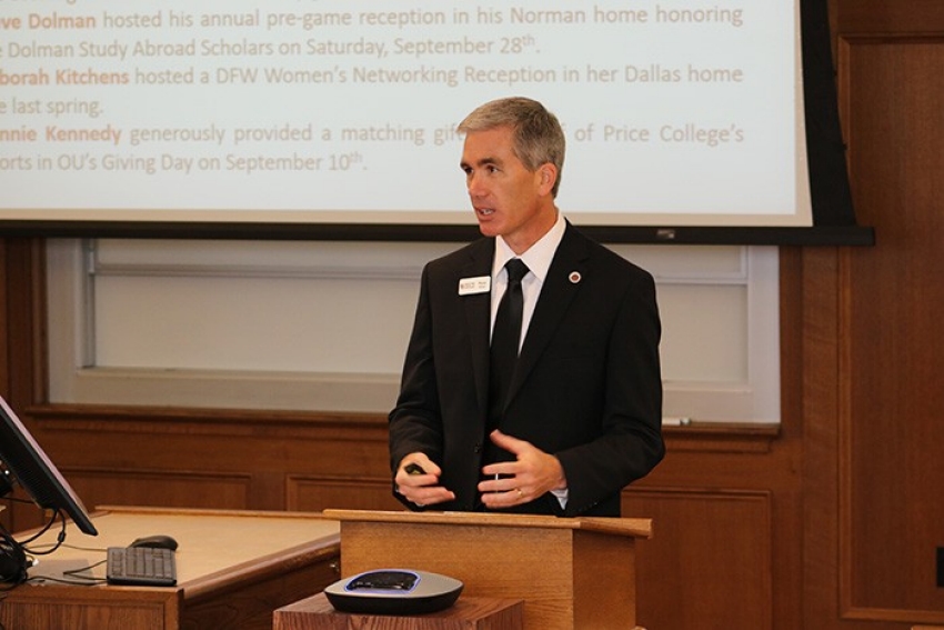 Interim Dean Wayne Thomas stands at podium