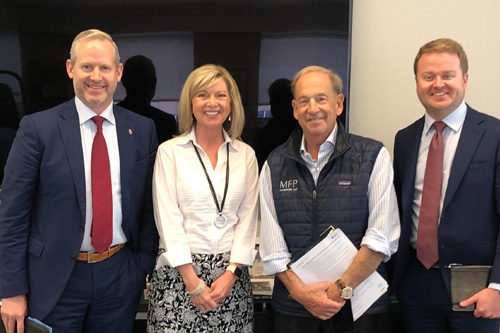 Dean Corey Phelps, Kristen Lazalier and Jared McDuffey pose for a candid shot with Michael Price (third from left) during a trip to New York.