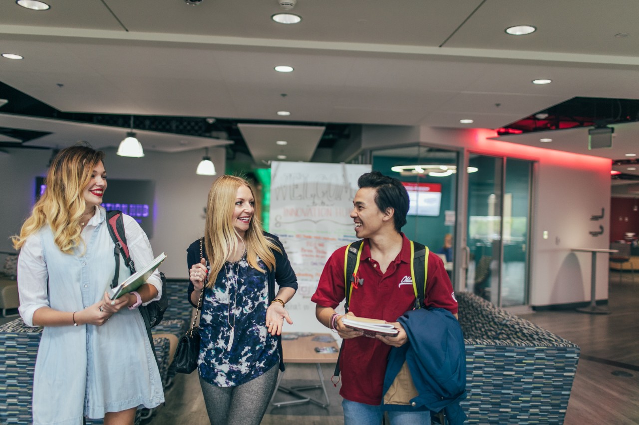 Students walking with alumni in Innovation Hub