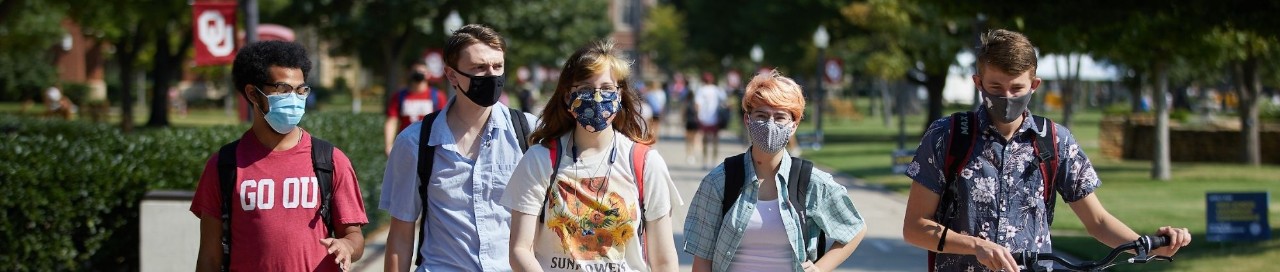 Five students walking on campus