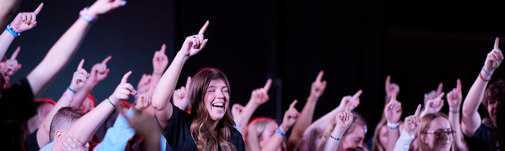 Students holding up their fingers at an OU event. 