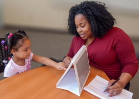 Brittany Swain does an observation with a child at a table.