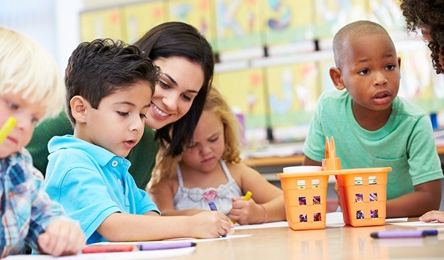 Group Of Elementary Age Children In Art Class With Teacher