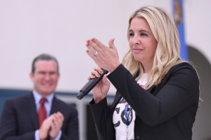 Aubrey Flowers, holding a microphone, addresses the assembly