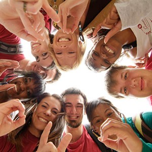 Students holding up OU hand signs