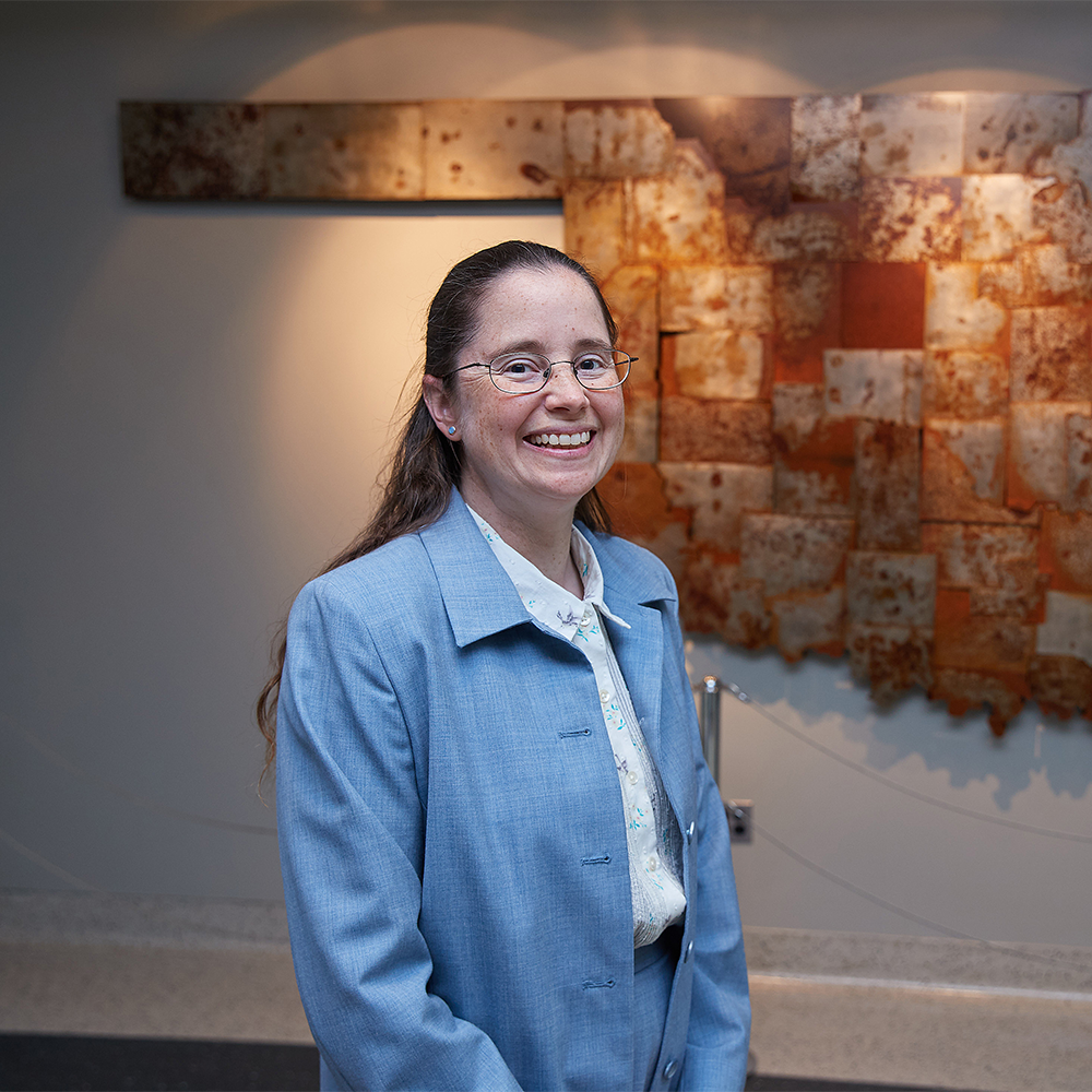 Portrait Amy McGovern in front of a sculpture of the state of Oklahoma