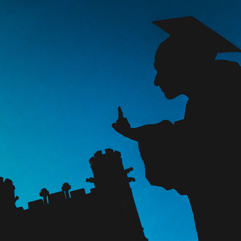 Graduate in cap near evans hall (decorative)